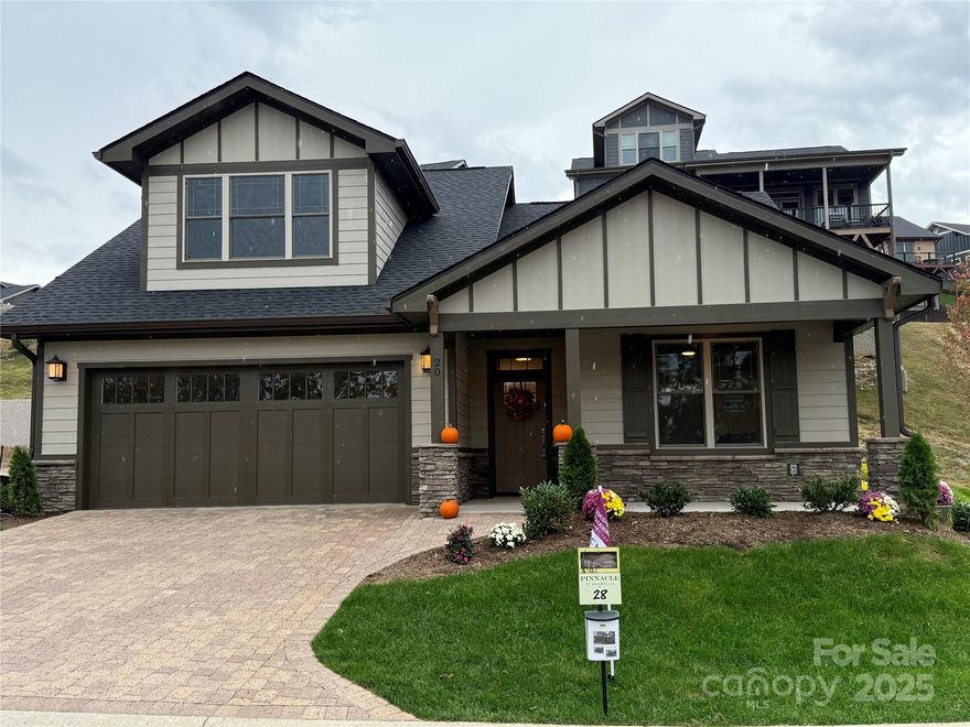 Designed to complement the natural beauty of its iconic location just minutes from the Biltmore Estate, this Craftsman-style home offers thoughtful main-level living with timeless details throughout. Vaulted ceilings in the great room and den create an open, airy feel, while hardwood floors, quartz countertops, and a gas fireplace bring warmth and sophistication. Covered front and back porches, along with a private side patio, extend the living space outdoors ideal for both entertaining and everyday enjoyment. With all lawn care handled by the HOA, you’ll have more time to take advantage of the community’s clubhouse, pool, fitness center, walking trails. Set within Pinnacle at Arabella, a gated community offering both privacy and convenience, this home is only minutes from South Asheville’s shopping, dining, medical care, and cultural landmarks.