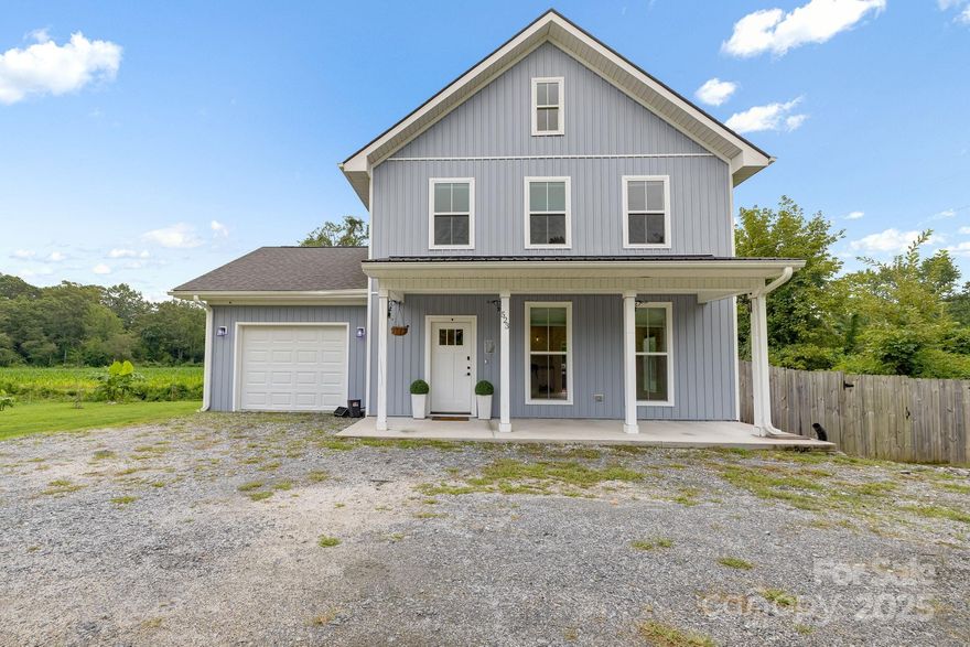 Experience modern living just minutes from downtown Hendersonville and historic Flat Rock. This newer construction home offers 3 bedrooms, 2.5 bathrooms, and an inviting open floor plan designed for both comfort and style. The main level features abundant natural light and an open layout for your living, dining, and kitchen. High-end touches include durable LVP flooring, a tankless water heater, and brand-new stainless-steel appliances. Upstairs, you'll find two spacious bedrooms, a hall bath, and a primary bedroom with ensuite. The attached garage provides excellent storage, while outdoor living shines with a covered front porch, a spacious deck, and a level yard surrounded by privacy fencing.  This property combines elegance, convenience, and value in one exceptional home. RARE assumable 4.25 FHA interest rate if you qualify!