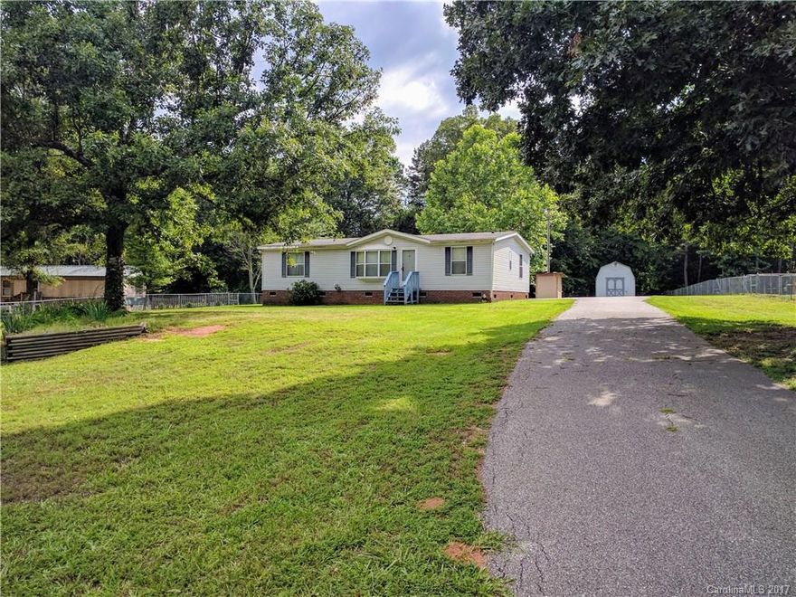 Come and enjoy peaceful country living with this 3 bedroom, 2 bath doublewide on almost an acre of land. Enjoy no HOA's, a large fenced in yard, and a large wired storage building in the back, brick underpinning, and a large, covered back deck. It's also less than 10 minutes to downtown York. This one won't last long!