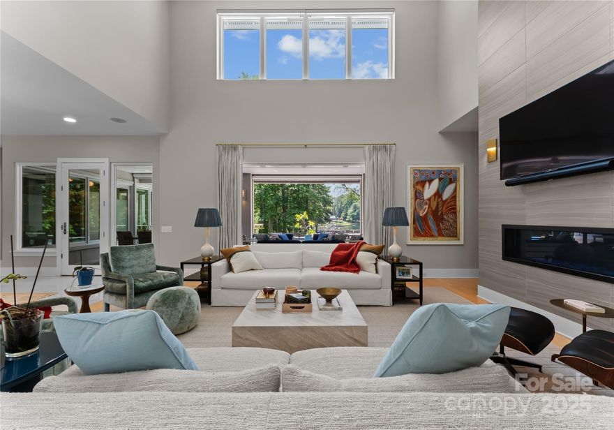 Rare Simonini-built contemporary waterfront home offering privacy, style, and flexibility with no HOA , CC&Rs, or rental restrictions. Situated on a sprawling 1.4-acre lot, this architectural gem is designed for effortless indoor-outdoor living. Soaring floor-to-ceiling windows flood the space with natural light while expandable sliding glass doors open to a covered lanai complete with ceiling heaters and an automated screen system, perfect for year-round entertaining. Inside, the chef’s kitchen is outfitted with top-of-the-line Thermador appliances and custom backlit cabinetry. Additional features include Sonos whole-house audio and Honeywell smart home automation managing HVAC, humidifier, lighting, security, and more! The luxurious Master bath features heated floors, digital showers, EAGO jetted soaking tub. Additional highlights include: custom wood stairs with cable railing, auto shades, high-end lighting by Visual Comfort, and a beautifully crafted home office with built-ins.