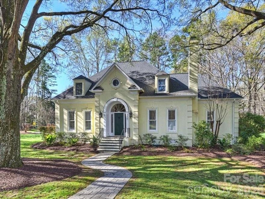 This beautifully built classic home welcomes you with an open foyer and a graceful, recessed staircase. The living room features a fireplace and sits opposite the formal dining room, creating an ideal layout for entertaining. A spacious kitchen with a breakfast bar opens to the family room, complete with a second fireplace. The primary suite is conveniently located on the main level and includes a well-appointed bath. A second staircase leads to a generous bonus room. Upstairs, you’ll find three secondary bedrooms and two full baths. Enjoy outdoor living in the beautiful backyard featuring a privacy wall and large patio. The wide  side yard is also well suited for soccer play or croquet. Ideally located just minutes from the amenities of Phillips Place and SouthPark.