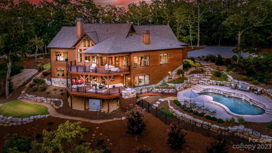 Search no more...your dream mountaintop estate at Lake Norman awaits where heaven & earth meet. Perched at the top of Little Mountain this 13.75 private estate offers beautiful sunset view of the Blue Ridge foothills & sunrise views of Lake Norman. This tranquil retreat was exquisitely designed & meticulously built in 2020 offering serine ambiance with walls of windows & soaring ceilings, bringing the outdoors in. Chefs will fall in love with the gourmet kitchen with Thermador appliances & huge center island. Entertaining is easy with the open floor plan of this home providing an effortless transition between Kitchen, Dining Room & Keeping Rooms all with fabulous mountain views. The lower level features a Guest Bedroom, Exercise Room, Entertaining area with a stone fireplace, media area, wet bar & tons of storage. You'll love relaxing on the 2 large covered decks, the built-in grill & a fenced inground pool. Ideally located with quick access to Charlotte, the airport, & Lake Norman.