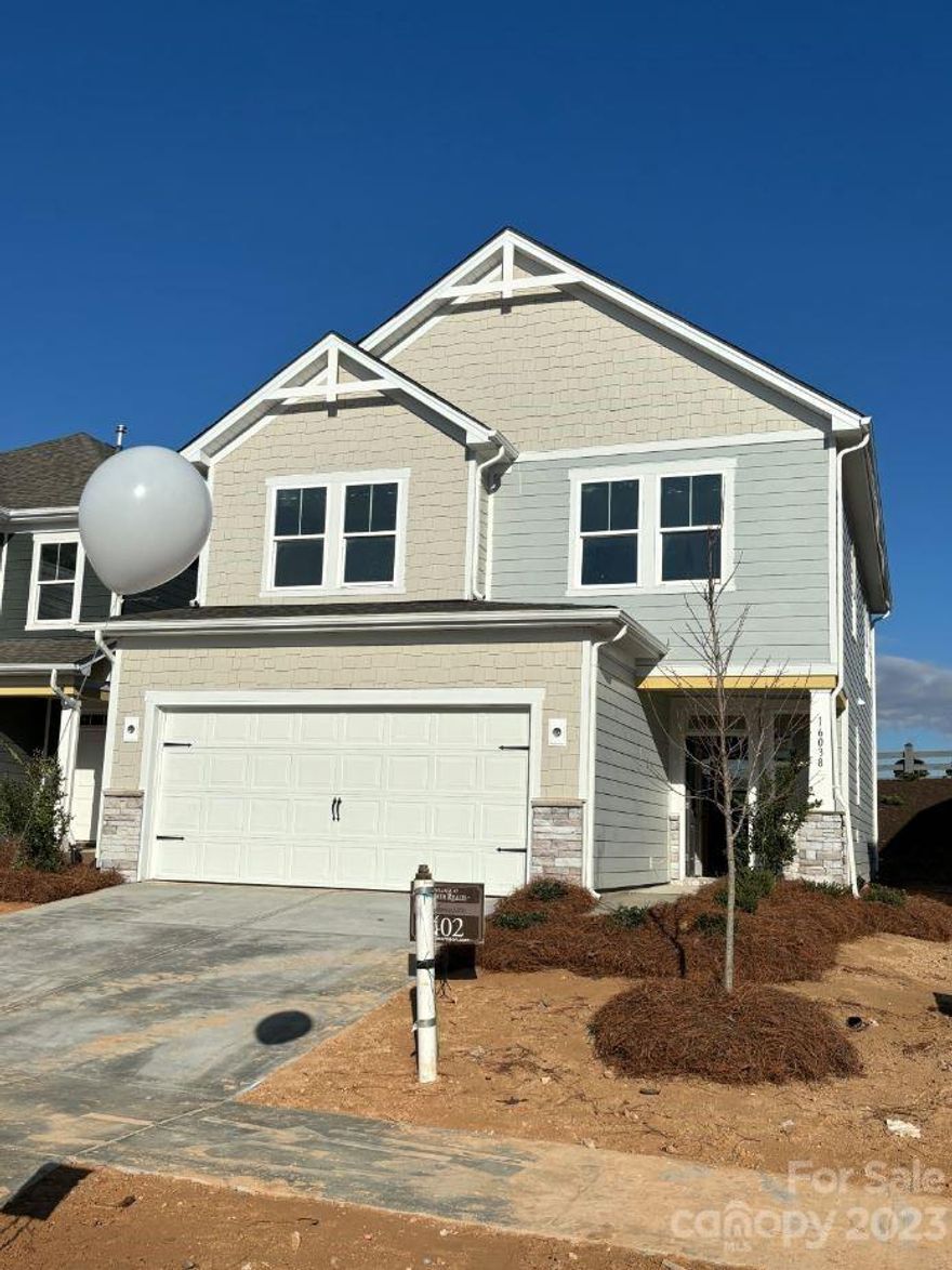 MLS # 4070977 Spring Completion! The Manteo is a 2-story home that includes a spacious great room, luxurious second-story owner's suite, a loft and two additional bedrooms. Enter through the foyer and walk past the half bath and staircase to reach the open-concept great room and kitchen area. Inviting outdoor living space is just past the casual dining area, providing additional entertaining potential. Upstairs you will find the owner's suite, two secondary bedrooms with a full bath, a laundry room, and a loft with tech area, perfect for a work from home space. Structural options include: drop zone and utility sink in garage.