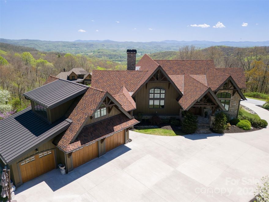 Rustic Luxury, Redefined: A Grand Highlands Masterpiece

Perched atop over two acres of pristine mountaintop landscape, this 6,000+ sq. ft. post & beam residence is a rare work of art — a home where timeless craftsmanship meets mountain grandeur. Constructed with Mill Creek Post & Beam’s Eastern White Pine timbers, every beam and rafter exudes warmth, strength, and understated elegance, creating a home that is both welcoming and awe-inspiring.
From sunrise over Bearwallow Mountain to sunset across Pinnacle Mountain, the long-range southern vistas stretch endlessly, unfolding over Hendersonville’s celebrated apple country. Inside and out, the home invites you to savor every moment, whether it’s curling up with a book and a cup of coffee, hosting lively gatherings with friends, or enjoying quiet, reflective sunsets with family.
Designed for both grand entertaining and intimate living, the home features a private theatre, elevator, and oversized garage with carriage house. The expansive outdoor living areas — anchored by a stone fireplace and seamless connection to the great room — provide a stage for unforgettable evenings against a backdrop of infinite mountain panoramas.
This is a residence crafted for a legacy, where every space reflects intention, luxury, and the natural beauty of the mountains. Rustic sophistication and mountain soul converge in spaces that flow effortlessly from indoors to outdoors, from lively gatherings to quiet retreats.
Beyond the gates, Grand Highlands offers a mountain lifestyle like no other. Enjoy a 12,000 sq. ft. lodge featuring a sports pub, event space, game room, library, and craft studio, or gather outdoors on the terrace beside the community fire pit and garden. Hiking enthusiasts will appreciate the onsite trail system and nearby Bearwallow Mountain trailheads, making adventure as effortless as leisure.
Centrally located between Hendersonville and Asheville, you are just 25 minutes from vibrant culture and entertainment and 25 minutes back to your peaceful mountaintop retreat. Here, every day balances serenity, excitement, and unparalleled mountain living.

This isn’t just a home — it’s a post & beam masterpiece, a canvas for memories, and a sanctuary for generations.

Community Amenities: 12,000 sq. ft. Lodge, Sports Pub, Event Space, Game Room, Library, Craft Room, Expansive Outdoor Gathering Areas, Community Fire Pit, Community Garden, Onsite Trail System, Planned Activities / Events / Clubs. Walking distance to public Bearwallow Mountain trailheads.