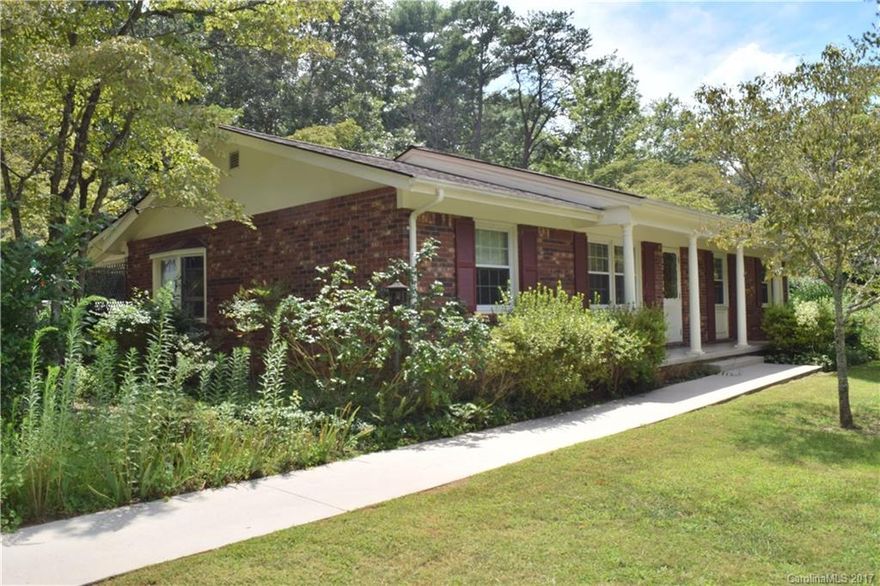 Great Botany Woods home on .80 maturely landscaped acres, sizable kitchen, lovely screened back porch, detached garage & carports, den, private setting, double paned windows, convenient East Asheville location