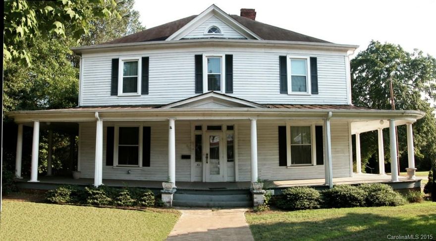Stately Colonial Columns greet guests on 10' wide wrap porch w/ beaded ceiling, leaded glass front door w/ sidelights. Enter into a 9' hall with grand staircase, living room & parlor, tiled fireplaces & dark natural woodwork. Spacious dining room with bay windows, wainscoting, fireplace & china cabinet. Kitchen has all appl & 2 pantries.  Master bed & bath down, laundry & 1/2 bath on utility porch. Upstairs 4 bedrms, bath, grand hall & attic access. Deck, Fenced bk yd & outbld. Insulated windows