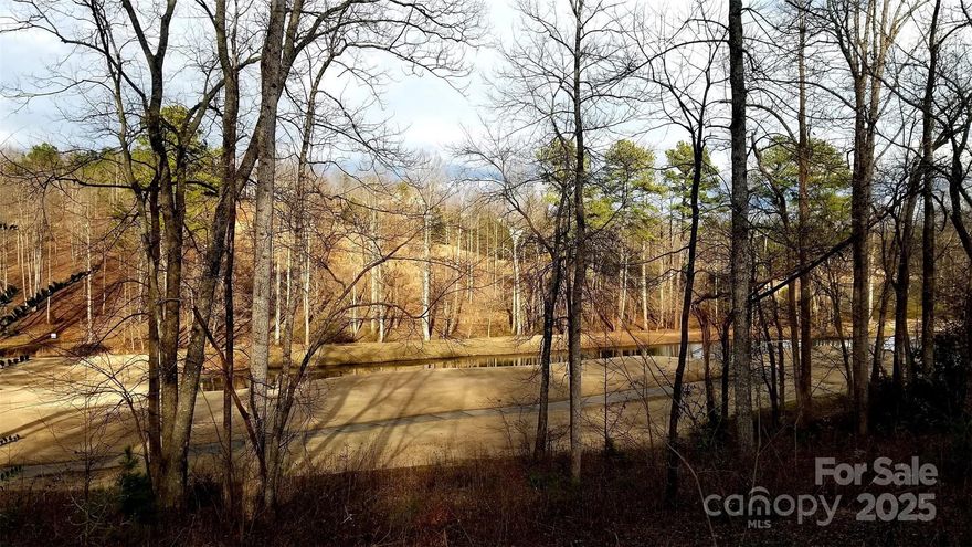 .91 acre golf course lot with sloping topography conducive to a basement foundation plan with frontage on a cul-de-sac, scenic views overlooking a fairway and pond in Silver Creek Plantation. Silver Creek Plantation is a community with amenities including an 18-hole Tom Jackson Championship Golf Course, clubhouse, pro shop, restaurant, outdoor community swimming pool, tennis courts, ponds, paved subdivision roads, public water and underground utilities. Nestled in the foothills of the North Carolina Blue Ridge Mountains, Silver Creek Plantation is conveniently located in a rural setting yet within an easy commute of Interstate 40, Lake James, Morganton's Historic Downtown and River Districts, entertainment, medical facilities, parks, recreation, restaurants, shopping and schools.