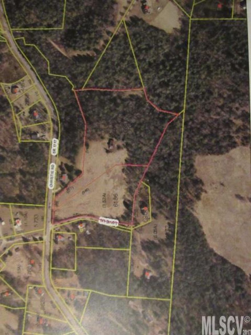 Gently rolling pasture (approximately 5 acres) sloping to creek at rear of property. Old barn on property with no value given.