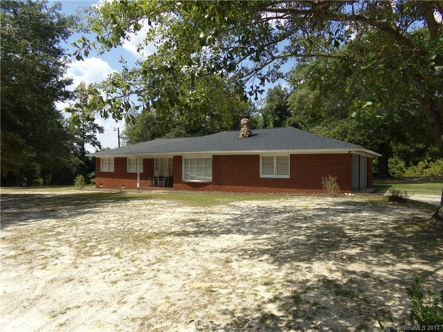 Don't miss this move in ready home located on 1.5 acres!  It has been updated in recent years throughout with a modern kitchen and large pantry that leads to the oversized laundry porch.  There is storage adjacent to the two car carport in addition to a detached storage/shop building. The den is spacious with a fireplace that is open to the dining room. This one won't last long!