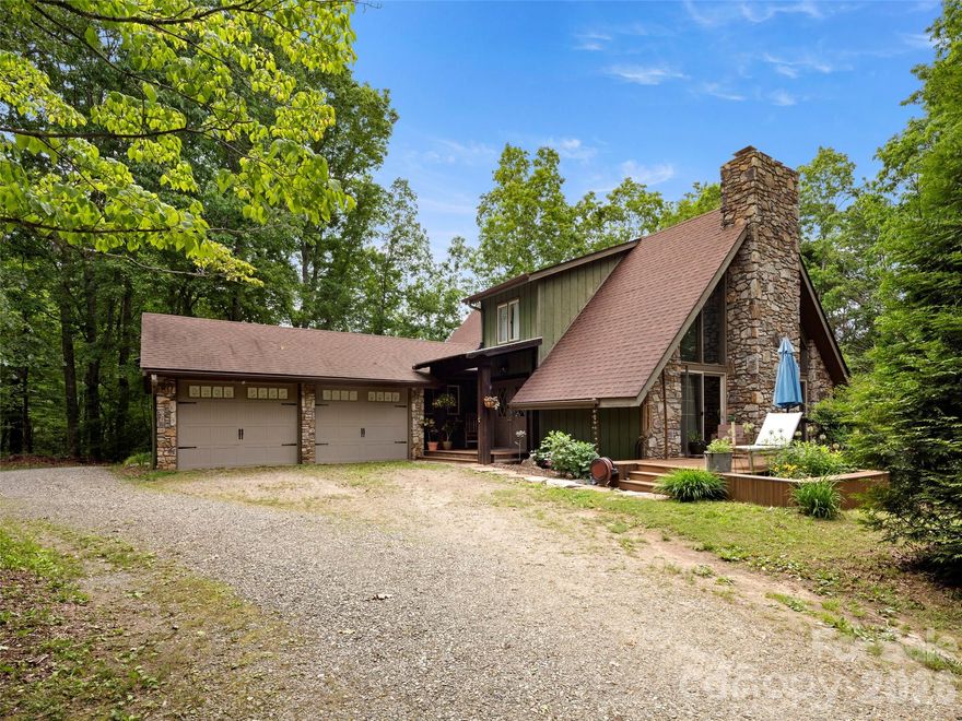 You’ll feel at home in this cozy, private 1,708 sq.ft A-frame style house, full of character and charm in the back of Bent Creek Neighborhood. This unique, light-filled 1985 home on 1.02 acres boasts mature landscaping, 4 bedrooms, and 2 updated bathrooms. The main living area is spacious and open, featuring a towering stone fireplace flanked by huge windows and emphasized by the cathedral ceiling. Cooking year round is a pleasure in the kitchen with granite countertops and sliding doors that open onto the covered deck. Create your home library in the upstairs loft. Natural landscaping around the home creates a seamless view into the woods, which you can enjoy during all 4 seasons from the 765 sq.ft wrap-around Trex deck with custom cedar benches. You’ll have ample parking and a 2-car garage with customized gear storage. The driveway winds down to 1,040 sq.ft basement with custom workshop space and a new well water filtration system. The home has a 2-zoned HVAC with WIFI app, 5-yr warranty, and oil heat HVAC connection. Buried utility lines make this a reliable home office location. Enjoy all the perks of Bent Creek neighborhood, including a playground, trails, and no HOA. You’ll live less than 5 minutes from the Blue Ridge Parkway, Pisgah National Forest trails, NC Arboretum, French Broad River, and less than 15 minutes to the AVL airport, Biltmore Estate, local restaurants, art, breweries, yoga studios, parks, and all the amenities Asheville has to offer. Make this house your new home in the perfectly private yet accessible location!