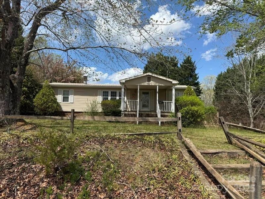 Wonderful 3.15 ac with 3/2 MFDW home with garden space and nice views.  Property also features a detached 2-car carport, ramp for ease of entry and a good portion of the property has fencing around a large pasture area with barns for animals and/or hobbies. Manufactured home is 1982 Mascot with 288 sf Sunroom added onto the back, and 199 sf covered front porch. Home needs some updates, but has good bones and has been well cared for.  Great storage in crawlspace, as well as an out building. There are beautiful mountain views in several directions, and the property directly adjoins the desirable Lake Adger Development! Other features include fruit trees, underground electric and multiple water hydrants for ease of watering garden and other outdoor projects.