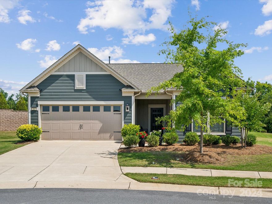 A MUST SEE located on the end of a cul-de-sac! This home is built on a highly desired premium lot, truly one of a kind! Spacious backyard with total privacy and large, beautiful porcelain tiles. The one-story bright and open floor plan features two bedrooms, two baths, a walk-in closet, an office, a sunroom, the great room, and kitchen with pantry everyone would enjoy. The interior of the home has been completely and tastefully customized and upgraded. Quartz counters throughout including a top quality quartz kitchen sink. KitchenAid stainless steel appliances, LG refrigerator, soft close cabinetry, roll-out trays, wastebasket, and under cabinet lighting. All bathrooms are fully tiled with shower glass enclosures. The laundry room provides a great storage area, cabinets, a large sink, and LG steam washer and dryer. There is a tankless water heater, an irrigation system, and a gas line stub at the patio. This beautiful home at Carolina Orchards offers many amenities to your liking!