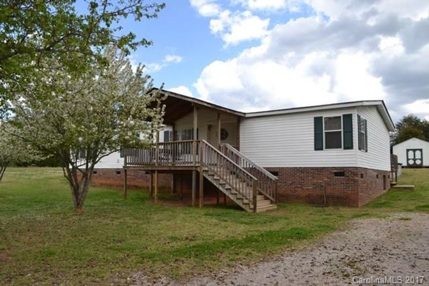 This double wide has brick underpinning and has a split bedroom plan. The cook in the family will love all the prep space in kitchen for preparing meals. MBR is very large with walkin closet. Master bath has dual vanity and shower. Tub has been removed but plumbing still there if you desire a soaking tub. The kids will enjoy the above ground mineral pool during the hot, humid summers. Man of the house will love the 16x24 wired workshop/storage building. York address, Clover schools. AS IS SALE.