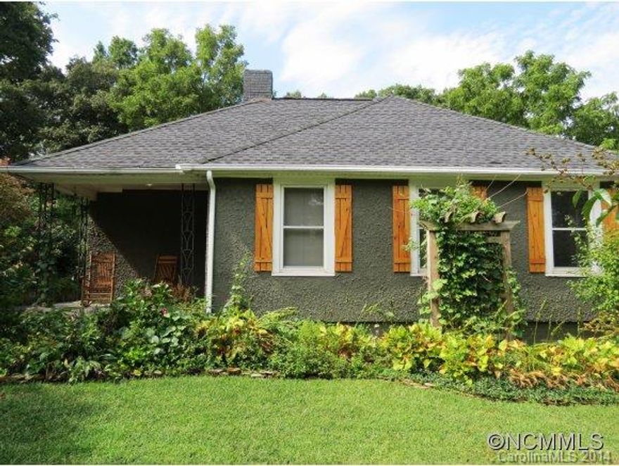 Historic Enka Village!Certified Wildlife Habitat!Unique 1930 stucco cottage w/english style landscaping and arts n crafts flair.Red oak flrs,hickory kit.cab&brick tile,open flr plan overlooking lush back yard,woodstove,trellised garden box(s)on 2 level deck,lrg parking area w/paved drive,serene nature deck-lower yard.Abundant wildlife & birds-including hummingbirds!100+ yr old grapevine!MLS ONLY-CALL NC LICENSED SELLER DIRECTLY W/OFFERS/QUESTION