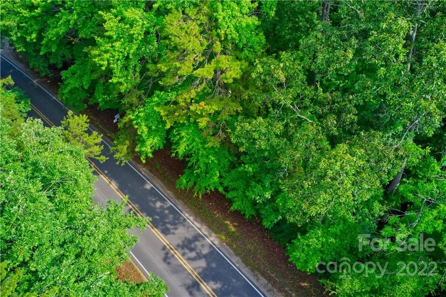 Private, wooded, and secluded 11.6-acre tract of raw, unimproved land in Matthews, NC, zoned for residential development in Union County. Ideal for a single estate or family compound with ample road frontage. Owner is willing to subdivide into four buildable lots: 2.7, 3.6, 3.2, and 2.2 acres. A building permit has been approved for a 4-bedroom home on the 2.7-acre lot. Conveniently located near Union County Public Schools, parks, golf courses (Olde Sycamore Plantation, Emerald Lake, Charlotte National), grocery stores, restaurants, Houses of Worship, Concord Mills Outlet Mall, and Novant Mint Hill Medical Center. Soil evaluation required for septic. Seller financing available