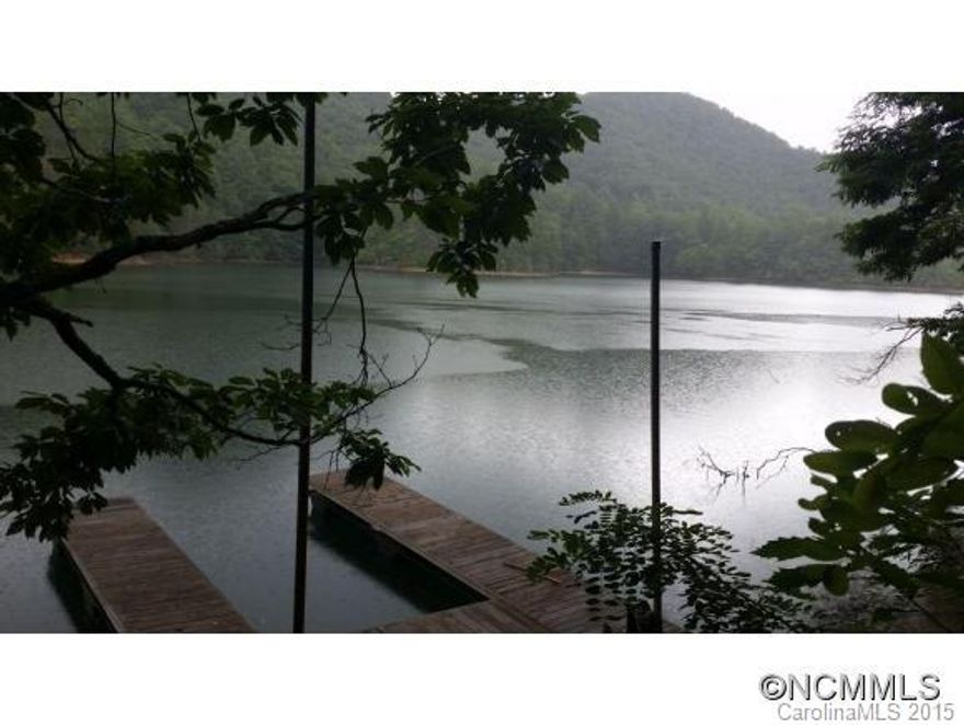 A respite from the masses.  6.37 acres with 770 feet of shoreline on Wolf Lake. Driveway graded, 13 gallon per minute well, 3 bedroom septic permit and 3 slip boat dock. Vast  portion of Wolf Lake shoreline owned by USFA. Tranquil lake setting and a peaceful place to be.
