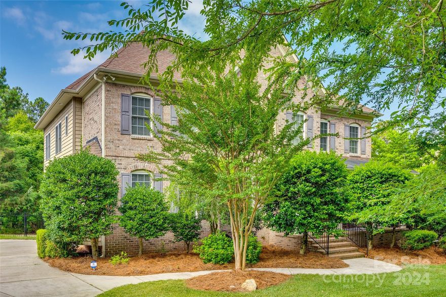 Nestled in the Lake Wylie waterfront community of Water Edge, this brick home sits on a spacious 1.26-acre lot and offers an unfinished HEATED basement, adding 1,157 sq ft to the living space. The basement is a blank canvas, ready for your creative touch, with electrical and PLUMBING already in place for an additional bathroom. Enjoy the charm of the tree-lined street and the welcoming front porch. Discover hardwood floors, a well-appointed library, Viking appliances, granite countertops, and quality hickory cabinets in the kitchen. The 2-story great room features a cozy corner fireplace. Upstairs, the primary bedroom is a retreat with a vaulted ceiling and a renovated bathroom featuring a freestanding bathtub and fireplace. Three additional bedrooms and a versatile loft complete the upper level. There is abundant storage throughout, a fenced yard, and a seasonal view from the community's Pool/Clubhouse overlooking the lake.