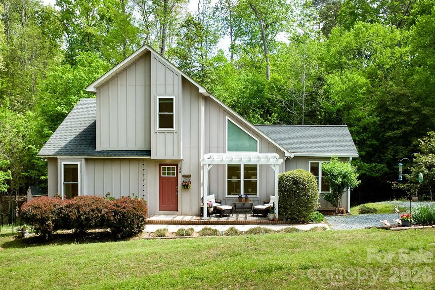 Tucked away on a quiet cul-de-sac in the Enchanted Forest of Woodrun, this charming custom-built home offers comfort, privacy, and a true connection to nature. Surrounded by mature trees and lush landscaping, 138 Uwharrie Court is a peaceful retreat just moments from Lake Tillery.

Inside, the open-concept living and dining area features a vaulted ceiling, abundant natural light, and a cozy fireplace—ideal for everyday living or entertaining. Gorgeous wood floors run throughout the kitchen, den, great room, and dining area. The thoughtfully designed kitchen flows seamlessly into the main living spaces, while the sunroom offers a bright, relaxing space to enjoy the wooded setting year-round.

The home includes 2 bedrooms plus a versatile flex room perfect for an office, guest space, or hobbies. A separate den with cathedral ceiling and mini-split adds flexibility. Additional features include Hardie board and batten siding, tankless propane hot water heater, tile shower in the primary suite, and ample parking.

Outdoors, enjoy a tranquil koi pond and multiple spaces designed for quiet mornings and peaceful evenings.
Located in the gated Woodrun community with amenities including a pool overlooking Lake Tillery, tennis/pickleball courts, basketball court, clubhouse, playground, and boat ramp. Boat slips and storage available for lease (waitlist), and short-term rentals are allowed.

Convenient to Morrow Mountain State Park and Uwharrie National Forest for hiking, biking, camping, and trail riding, as well as the nearby towns of Albemarle, Norwood, Badin, Mount Gilead, and Troy for dining and shopping. Lake Tillery also offers waterfront dining and multiple marinas.

Enjoy the tranquility of lake living with convenient access to Charlotte, Winston-Salem, Raleigh, Durham, Pinehurst, and Greensboro.

138 Uwharrie Court is a cozy, lake retreat that feels straight out of a storybook.