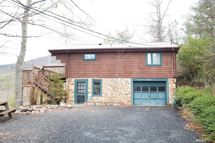 Gorgeous Mountain Views Main Floor = +/- 700 SF, Great room with fireplace & open to the outdoor living spaces, open kitchen with full appliances, 2 bedrooms, and full bath. Lower Level = +/- 450 SF, den, laundry, and access to garage.  The remaining lower level is a drive in garage and workshop space. The outdoor living areas are fantastic with open decking and the mountain views.  Most furnishings are included!