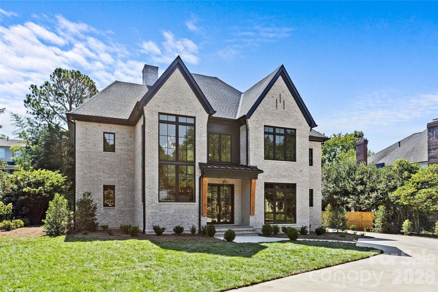 Drawn by acclaimed architect Robert Foster and built by Westwood Custom Homes, this Old Cotswold stunner delivers refined, modern sophistication in one of Charlotte’s most coveted neighborhoods.
A soaring two-story foyer with hardwood herringbone inlay sets the tone, complemented by bountiful natural light, curated interiors, and custom trim throughout. The chef’s kitchen features bespoke cabinetry, a 46" Wolf range, and a show-stopping scullery with exceptional storage, wine and beverage fridges, and a second dishwasher—designed for those who love effortless entertaining.
The Great Room is anchored by a wood-burning Isokern fireplace and opens through a retractable glass wall to a covered outdoor living space complete with a gas fireplace, built-in heaters, and a gas grill. A glamorous pool with an integrated spa creates seamless year-round indoor/outdoor living.
The main-level primary suite offers a vaulted ceiling, oversized windows with custom window treatments, and a spa-inspired ensuite with a soaking tub, dual vanities, and a zero-entry shower. The expansive walk-in closet includes an integrated washer and dryer, completing the retreat.
A main-level office with an adjacent bath doubles as a guest suite, while the second level offers three ensuite bedrooms and a flexible living space with a dry bar and dedicated half bath. The large laundry room adds ideal everyday functionality. A nearly 400-square-foot private suite over the garage provides additional space for guests or a secondary office.
1321 Ferncliff delivers elevated design, exceptional craftsmanship, and true resort-style living.