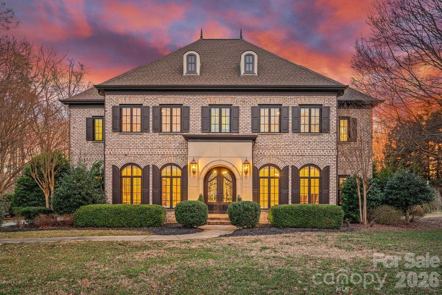 Welcome to 123 Cape Cod Way, a timeless all-brick custom residence ideally situated in the prestigious community of The Point. Set on a beautifully flat and meticulously manicured 1.48-acre homesite, this Simonini-built home offers exceptional privacy, quality craftsmanship, and enduring appeal.

The four-bedroom, four-and-a-half-bath floor plan is defined by coffered and tray ceilings, refined architectural detailing, and expansive windows that flood the interiors with natural light. An open, airy layout provides effortless flow for both everyday living and entertaining.

Outdoor living is seamlessly integrated with a screened rear patio overlooking the pool and fully fenced backyard, offering privacy, functionality, and space to enjoy the expansive lawn. A three-car garage with its own dedicated heating and cooling system adds versatility and comfort. Major updates include upper and lower HVAC systems replaced in 2022 and a new roof in 2022.

Completing this exceptional offering is a dedicated boat slip (Pier Z #46), providing convenient access to Lake Norman and the coveted lake lifestyle.