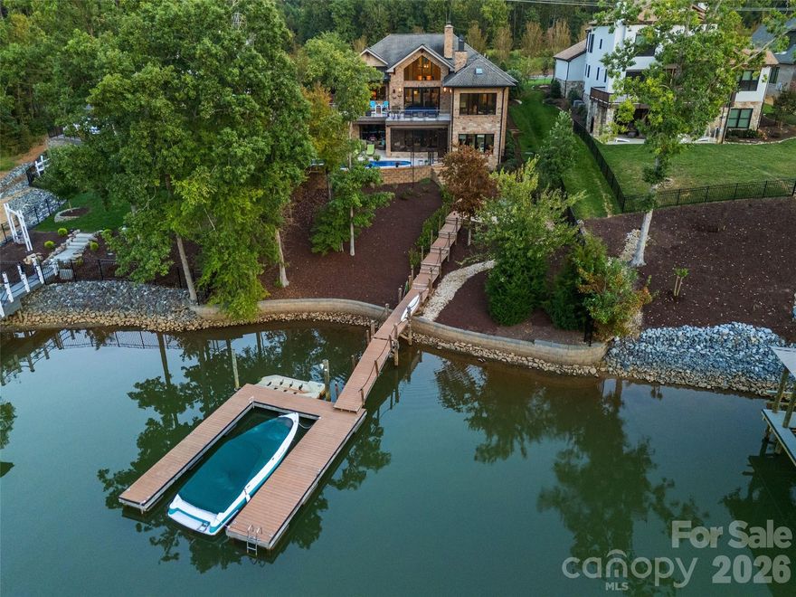 Luxury, sunset view Lake Wylie waterfront living at its FINEST! This custom built, 2 story home features high end finishes throughout, resort style pool & spa, plus a private dock located in a quiet cove with immediate access to the lake & is located in the beautiful, gated community, Reflection Pointe. The home features 5 bedrooms, 4 full bathrooms, 1 half bathroom, 4,704 heated square feet & 2,689 unheated square feet, incredible indoor/outdoor living with sliding doors to the main level porch & lower level screened in patio, outdoor fire pit & fenced in backyard with beautiful landscaping. Main level features incredible lake living with sunset views, 2 bedrooms, 2 full bathrooms & 1 half bathroom. Stunning chef's kitchen has cherry & maple cabinets, granite countertops, oversized island with seating, dual built-in stainless steel Frigidaire refrigerator & freezer, stainless steel appliances, prep sink in kitchen island with disposal, large butlers pantry with additional sink & dishwasher, & bar with ice maker. Kitchen overlooks the light filled, vaulted living room with a French marble fireplace & sliding door access to the deck. Primary suite has stunning lake views, gas fireplace, sitting area/office, double vanity, shower, bathtub, water closet & walk-in closet with access to the laundry room. Secondary bedrooms are spacious & private. Two car garage has epoxy floors, separate workshop, sink & large drop zone when you enter the home. Lower level features an oversized family room with gas fireplace, 3 bedrooms, 2 full bathrooms, incredible walk in storage & sliding door access to the screened in porch. Additional features include 10 foot ceilings on main & lower levels & 22 foot ceilings in the foyer, dining & living rooms, mahogany wood floors on main level, 3 gas fireplaces throughout, full brick & stone exterior, newly updated & refinished pool system to include new plaster, all new pumps & blowers, Hayward 440,000 BTU pool & spa heater & much more (see attached features list). Neighborhood amenities include gated community, Lake Wylie waterfront, clubhouse, lagoon swimming pool, lighted tennis & pickleball courts, walking paths, beach area on Lake Wylie, playground, boat storage, boat slips, boat launch canoe, kayak dock & storage & pavilion. Just minutes away by boat of Morningstar Marina, Papa Doc's, Lake Wylie Marina & Drift, & within close proximity to the finest shopping, dining & activities to include the CLT airport, Daniel Stowe Botanical Gardens, US National Whitewater Center, Rivergate Shopping Center, Lake Wylie Shopping, Berewick Town Center, Charlotte Premium Outlets, Tega Cay Shopping Center & more. A must see home!