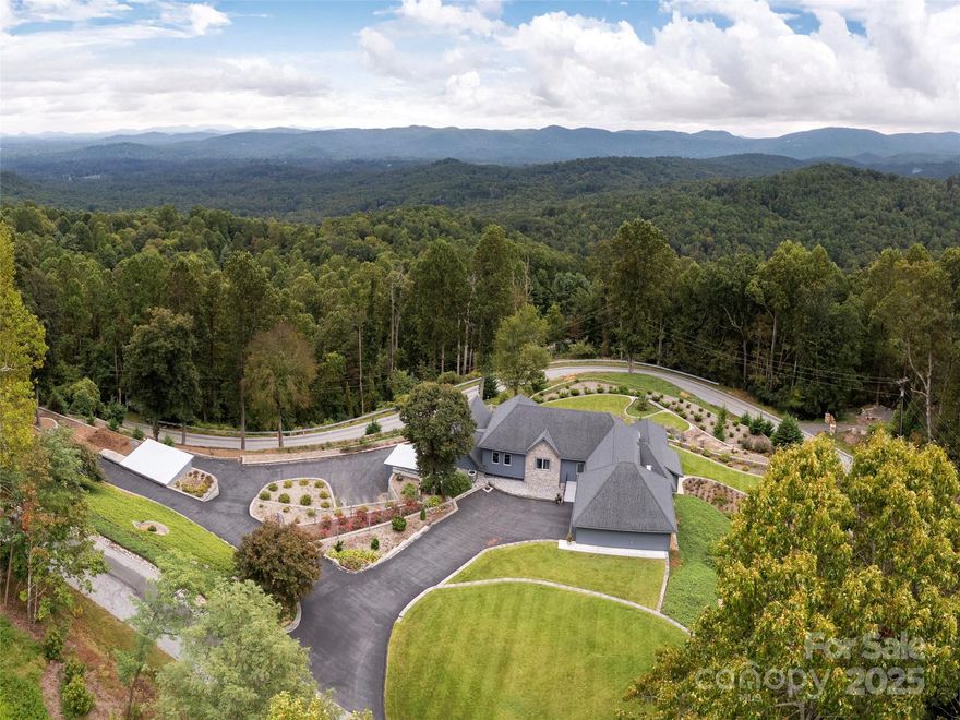 Captivating Luxury with a Unique Floor Plan! Step into a world of elegance and innovation with this stunning mountain property. The primary living spaces are thoughtfully situated on the lower level, merging style and functionality for an exceptional living experience. This home boasts energy-efficient hot water radiant heat set in sleek concrete floors, and with its southern exposure, natural light fills every room, enhancing comfort throughout the seasons. The heart of the home is the open kitchen with its spacious island, premium gas Thermador cooktop, and stylish metal tile subway backsplash. The luxurious primary suite features a dramatic hall of closets, a spa-inspired bath with tile step-in shower, a dedicated alcove for a hot tub or freestanding tub, and a two-sink vanity for ultimate convenience. Additional spaces include a guest bedroom and second full bath, an adjoining workshop for creativity, a bedroom with en-suite bath on the upper level, a large fitness room, and a bonus room ideal for hobbies or a personalized workspace. A separate outbuilding with overhead door provides endless possibilities, from vehicle storage to crafts. Outdoors, breathtaking long-range mountain views capture both sunrise and sunset, offering beauty from dawn to dusk. This extraordinary property is a harmonious blend of luxury, efficiency, and inspired design!