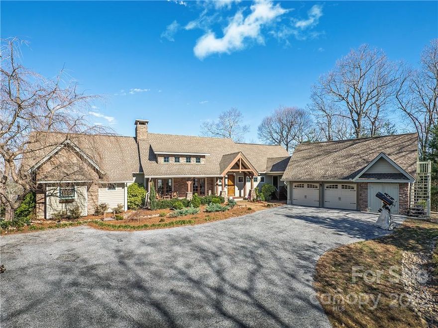 Exceptional modern timber frame home on private 8 acres with sweeping long range mountain views from nearly every room! Enjoy the peace & quiet with the convenience of an 8 minute drive to Flat Rock & a 15 min drive to downtown Hendersonville! Extensive renovation in 2014 to add square footage, increase deck spaces, & add a two car garage w/ gym space above. Redesigned kitchen w/custom crafted cabinets, commercial Thermador refrigerator, Wolf gas range, & granite counters. New primary bath w/heated floors, custom vanities, glass shower, & soaking tub. Private deck w/hot tub & sitting area to enjoy the view. Main level guest suite w/private screened porch. Three fireplaces, lower level den w/wet bar. Two guest bedrooms, Jack & Jill bath, & plenty of storage space also on lower level.