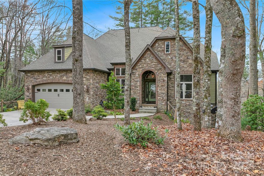 Welcome to your perfect escape, nestled amidst the serene beauty of Connestee Falls in the WNC Mountains. This delightful property offers a unique blend of charm and modern comforts, making it ideal for those seeking tranquility and relaxation. Surrounded by lush greenery and beautiful hardwood trees on a 2.742-acre lot, it offers breathtaking mountain views and a sense of seclusion while still being conveniently accessible to nearby amenities and attractions.  
Step inside to discover a warm, inviting interior with well-appointed living areas bathed in natural light. The open floor plan seamlessly connects the living room, dining area, and kitchen, creating an ideal entertaining or unwinding space. Retreat to one of the comfortable bedrooms (there are four bedrooms, three of which are en-suite), each offering a peaceful sanctuary to rest and rejuvenate after exploring the area. The owners have created a perfect oasis for the new buyer. See why we love living where we play.