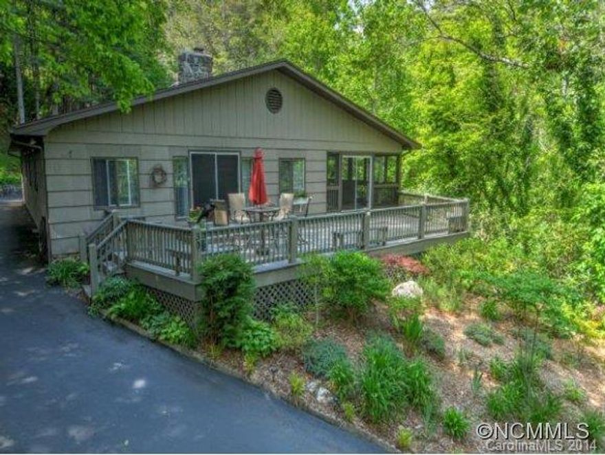 Charmer above Maggie Valley Club. 2 bedroom, 2 bath home with many updates. Stunning hardwood floors, wood burning stone fireplace, all season room, office space, creek, "cooks delight" kitchen,large deck to enjoy the summer evenings. Well landscaped yard, outbuilding for extra storage, double car garage.  A must see!