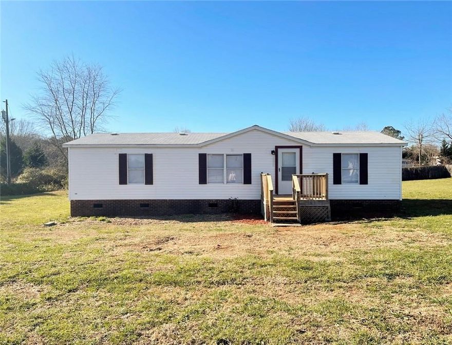 *UPDATES: new roof 2023, new paint, new PEX plumbing throughout, replumbed well, fresh gravel, the list goes on!!* 3 BR/2 BA doublewide with NEW flooring, carpet, and paint. Split bedroom floor plan. All bedrooms have WIC.  Fenced-in lot. 2-story outbuilding perfect for storage or workshop. Plenty of yard for pets, gardening, or entertaining.  Crawlspace has new vapor barrier and has been repaired to FHA standards.