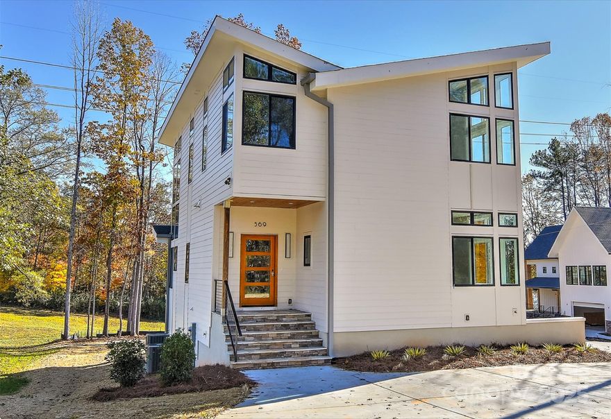 Discover modern luxury living with this stunning new construction home, conveniently located on a quiet deep-water Lake Wylie cove just minutes from the Boyd bridge.  This architectural masterpiece features sleek, contemporary design elements that blend seamlessly with the natural surroundings.  Floor-to-ceiling windows with soaring ceilings and rooflines offer breathtaking views of the lake, while open-concept living spaces provide an airy light filled home.  State-of-the-art kitchen boasts high-end appliances and minimalist finishes, ideal for casual living and sophisticated entertaining.  Expansive deck areas allow indoor-outdoor living.  Private dock area allows you to build your own dock for boating and waterside gatherings.  Ground floor features a potential in-law/guest suite/laundry with private entrance.  The main floor and upper floor offer multiple bedroom/flex room areas, with magnificent views. Upgrades throughout, closet systems, hot water recirculator and more!