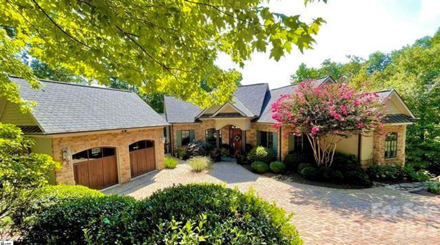 Welcome to 115 Blazing Star Trail in the highly sought-after Cliffs at Glassy, where luxury & comfort come together effortlessly. Set at a 2,600-foot elevation with seasonal southeast views, this home is enhanced with thoughtful upgrades, & its design seamlessly integrates indoor &outdoor living. Perfect for both intimate gatherings & overnight guests, the layout provides spacious common areas alongside private retreats, all connected by an inviting flow. Expansive windows & strategically placed doors flood the interiors with natural light & open to tranquil outdoor spaces, ideal for enjoying the mountain setting year-round. This home embodies a lifestyle of sophistication, ease, & harmony with nature. The private setting & welcoming approach create the perfect introduction to this meticulously maintained home. Inside, the main level opens to a spacious great room with soaring vaulted ceilings & a dramatic two-sided stone fireplace. The open layout seamlessly connects to the chef’s kitchen & adjoining dining room, ideal for both everyday living & entertaining. Designed with style & functionality in mind, the gourmet kitchen features a gas 4-burner Wolf cooktop with grill, wine fridge, a newly expanded granite island with bar seating, & numerous upgrades, includingSub Zero & Wolf appliances, a trash compactor, & sink. Ample cabinetry & a built-in desk nook add thoughtful touches for convenience &organization. Just beyond the dining room, discover two inviting outdoor living areas. A charming screened porch with an outdoor gas fireplace provides a cozy spot to relax in comfort, while the newly expanded deck offers a private retreat for morning coffee, alfresco dining, or simply soaking in the natural surroundings. Together, these spaces set the stage for year-round enjoyment, whether entertaining guests or savoring quiet moments amidst the mountain scenery. The expansive primary suite offers a true retreat, accented by a vaulted ceiling & a recently renovated spa-like bath featuring dual vanities, a soaking tub, private water closet, & a walk-in shower with dual shower heads, including a rainfall feature. Two generous walk-in closets with custom systems & updated lighting provide both style & functionality. Also on the main level,the expanded laundry & mudroom includes abundant pantry cabinetry & a sink for added convenience. A stylish powder room & a dedicated office complete this level. The lower level showcases a generous living room with a wet bar, & gas fireplace creating the perfect space for entertaining. Two guest bedrooms & two full baths, including one with direct access to a private deck, provide comfort & privacy, while three unfinished storage rooms offer abundant space for organization or future customization. Outdoor living continues on this level with a spacious deck that seamlessly extends the home into nature & even stays dry during rains. Relax in the hammock featured in a private area with cool breezes. Framed by the tranquil beauty of the mountains, this inviting retreat is ideal for relaxing, entertaining, or simply enjoying the serene views year-round. Additional features of this remarkable home include an oversized two-car garage & a charming flagstone walkway with artistic concrete railings that meander around the property, creating a peaceful nature path. Notable updates include, refreshed landscaping, elegant entry door, retractable screens on the front & deck doors, updated interior & exterior paint, a LeafFilter system, two new HVAC systems, new water tank with constant hot-water flow, & a whole-home generator with surge protection (2025). Just a short drive from the clubhouse along the18th fairway, & community amenities, this residence offers both convenience & luxury in one of the area’s most desirable settings. Offered mostly furnished with select exclusions. A Club membership at The Cliffs is available for purchase with this property giving you access to all seven communities.