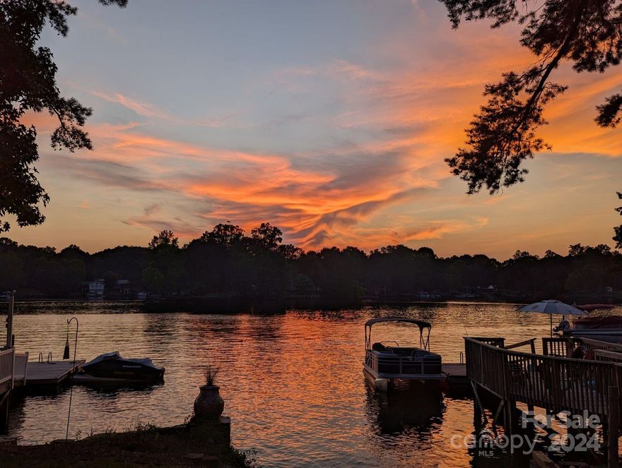 Tucked away in a charming pocket of Abbott's Creek on High Rock Lake you will find this immaculate home with both a private dock and a ramp! The concrete ramp is "grandfathered in". New ramps are no longer approved. So there is definite added value when you can put your boat in from your own boat ramp on your property. This delightful home offers affordability that doesn't compromise on comfort - and talk about the views! WOW! Check out these sunsets just waiting for you to enjoy after a hard day at work or play on the lake. Home comes fully furnished, including all of the outdoor furniture as well as the canoes! It truly is ready for you to step right in and begin enjoying your new lake home before summer arrives! Home is on a permanent foundation, and has a partial basement. Septic pumped on 2/22/24. Furnished home has been recently remodeled and freshly painted for you. One car garage / storage for your toys. What more could you ask for?! Come enjoy the quiet life and sunsets here!