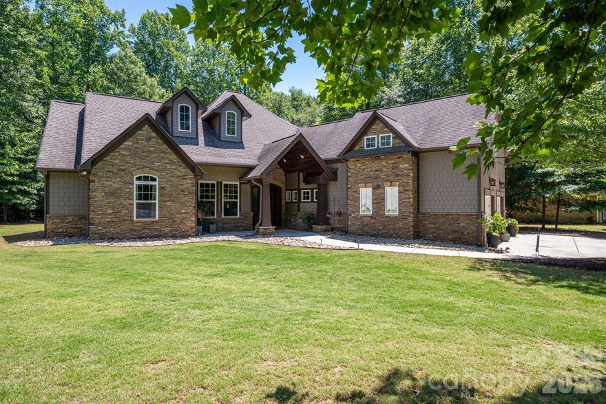 Escape to this stunning, custom-crafted 3-bedroom, 2.5-bathroom estate offering unparalleled privacy on a massive flat lot (almost an acre) just steps from the lake in the heart of Lake Wylie. The striking exterior blends hard-coat stucco, hardboard shakes, and natural stone for premium curb appeal, complemented by a sleek side-load 2-car garage. Inside, the home opens into an airy grand living space featuring soaring 14-foot ceilings, a stacked stone gas fireplace, and a freshly painted interior.

Designed for low maintenance and luxury, the floor plan features zero carpet—only timeless wood look plank tile throughout. Entertain with ease around the massive center island in the gourmet kitchen using the built-in wine fridge, gas cooktop and warming drawer.  The primary retreat overlooks the private backyard and has a the luxurious features you expect in a home of this caliber. Secondary beds both on main floor as well and have huge closets. Also, just off the foyer is a dedicated home office which could also be a 4th bedroom or head upstairs to the huge bonus room. There is also finished space (being used for storage) that can be finished as another full bath if needed (plumbing located just below it). The private backyard features a huge covered outdoor living space perfect for relaxing and enjoying the wildlife. At the back is also a 16x16 storage building and a firepit.  Mechanical excellence defines this home, boasting three separate HVAC units, a tankless gas water heater, and a massive amount of attic space with high potential for a third-floor conversion. Best of all, the oversized property features a full RV hookup wired for 50-amp service. Enjoy lake-side living with total freedom and absolute seclusion. And the best part, NO HOA!!!