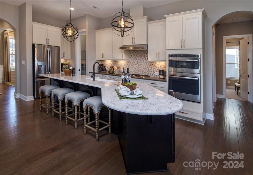 MLS # 4109718 REPRESENTATIVE PHOTOS ADDED.  The Whitmore II at Meadow Vista is a spacious ranch plan, the core of which is the open-concept entertaining space featuring a large gathering room, a casual dining area and stunning kitchen with a unique boomerang-shaped center island. For formal affairs, a dedicated dining room is located around the corner next to the foyer. Unique features of this new Charlotte area home include walk-in closets in secondary bedrooms and a long 2-car garage allowing for extra storage. The spacious owner’s suite includes a luxurious bath, large walk-in closet, dual sinks and the convenience of a dedicated shower enclosure plus soaking tub. Structural options include: shower  in bath 2, second suite, screened covered patio, laundry sink.