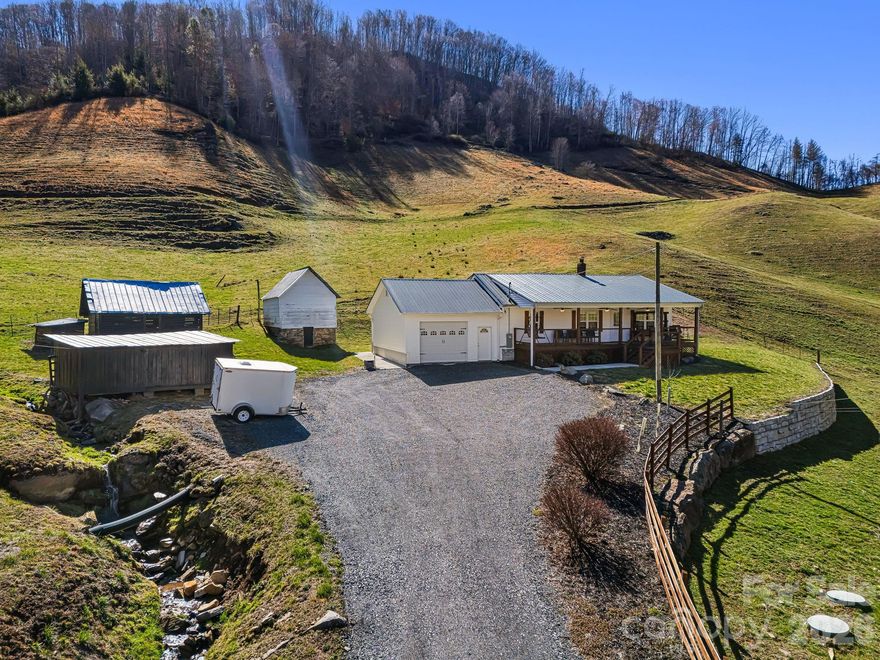 SELLER OFFERING OWNER FINANCING! REDUCED TO SELL! Welcome to 867 Indian Creek Rd—your mountain dream retreat nestled in the heart of Burnsville, NC. Set on 63 acres of unrestricted land, this one-of-a-kind property offers endless possibilities. From homesteading to multigenerational living or simply enjoying peace and privacy of wide-open space, this is a rare find. The beautifully completely updated farmhouse features 2 cozy bedrooms, 1 full bath, and timeless charm throughout. Step outside to discover a spring house, a large barn perfect for animals or storage, and a soothing creek that runs through the land. Located a short drive to downtown Burnsville, Asheville, NC, and Johnson City, TN. Whether you’re seeking serenity or a place to build your vision, this property is ready to welcome you home. Don’t miss out—schedule your private tour today and experience the magic of Indian Creek for yourself.