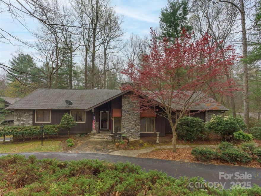 Explore one of Hendersonville's premier neighborhoods, Timber Creek, located in Laurel Park. This custom-built 3 bedroom, 3 1/2 bathroom home is situated in the heart of Timber Creek, surrounded by mature ornamental trees, well-maintained landscaping, and hardwoods. The main entry of the home leads into an expansive great room with vaulted ceilings, a floor-to-ceiling real stone fireplace. The sitting area receives ample natural light. The 2,100+ square feet on the main level includes a formal dining room, kitchen, wet bar, breakfast room, pantry, laundry room, 3 bedrooms, and 2 1/2 bathrooms. The 1,200 square feet of basement level offers a large entertainment room, family room, office, significant storage space, and bonus room. The basement also includes a 2-car garage, additional storage, and workshop area. Schedule an appointment today!  No Home Damage Sustained During Helene.  Schedule your appointment today! HOME SOLD AS IS.  SELLER WILL NOT BE ABLE TO MAKE REPAIRS