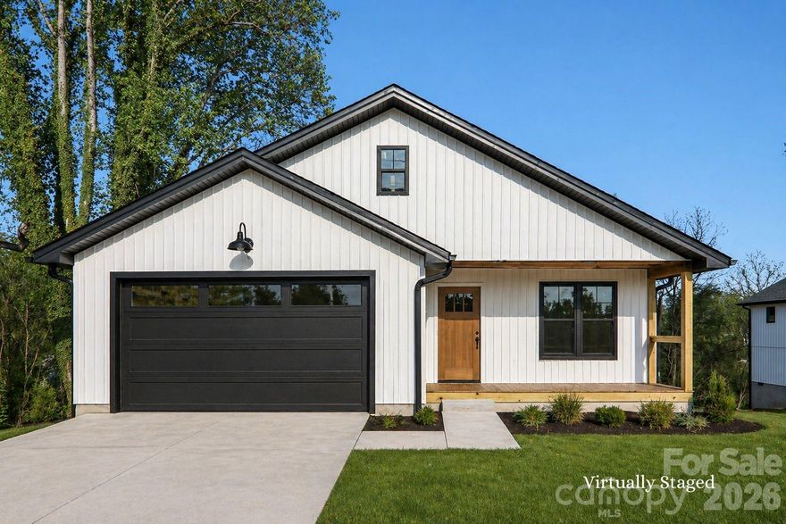 Very rare opportunity to own a brand new home in the heart of downtown Mars Hill, listed below appraised value with the appraisal uploaded in MLS. Buyers can walk in with positive equity from day one. Thoughtfully designed for easy, one level living, this 3 bedroom, 2 bath home offers a one step entry, smooth mobility friendly flooring, and a layout that lives beautifully now and for years to come. Inside, the open living, dining, and kitchen area feels bright and welcoming with vaulted ceilings, fireplace, and a natural flow for everyday living or gathering.
The primary suite is peaceful, with a spacious walk in closet, double vanity, and beautiful walk in tile shower. Every detail was chosen to feel fresh, warm, and timeless with clean finishes, natural textures, and modern lighting. Enjoy the covered front porch with year round views of Bailey Mountain. The covered back deck offers another quiet place to enjoy the cool mountain air, w/winter views of Craggy Gardens. The two car garage provides room for storage, plus a dedicated storage closet for the things you want tucked neatly away.
The location is where the magic is. Live right on Main Street in the charming town of Mars Hill, where you can walk to restaurants, the post office, medical offices, Mars Hill University, the local theater, and downtown events. Don’t miss First Fridays, the Bailey Mountain Cloggers, or the everyday joy of living in a small mountain town that still feels like a community.
Step outside and enjoy access to one of Mars Hill’s favorite traditions, the famous 3 mile Loop, a beloved in town route that connects you to the rhythm of the neighborhood and leads toward The Bailey Mountain Preserve. Bailey Mountain is one of the town’s treasured landmarks, offering 300 acres of conservation land, miles of trails, mountain views, and protected green space for generations to enjoy.
This location also puts you close to so much of what makes Western North Carolina special. Downtown Marshall & Weaverville are about 15 minutes, Burnsville and Asheville 25 min. 45 min to Johnson City, TN giving you easy access to two vibrant regional hubs, both with regional airport options nearby. 20 min to Hatley Pointe, with year round fine dining, skiing, dining, and a lift access mountain bike park planned for 2026. Rafting, floating, biking, hiking, local food, mountain views, and small town events are all part of everyday life here.
Homes like this simply do not come along often: brand new construction, Main Street location, one level living, covered outdoor spaces, mountain views, garage storage, and a front row seat to Downtown Mars Hill life. Sister home next door is also available, creating a unique opportunity for buyers looking for nearby living, investment potential, or simply two beautiful new homes in one of Madison County’s most special small towns.