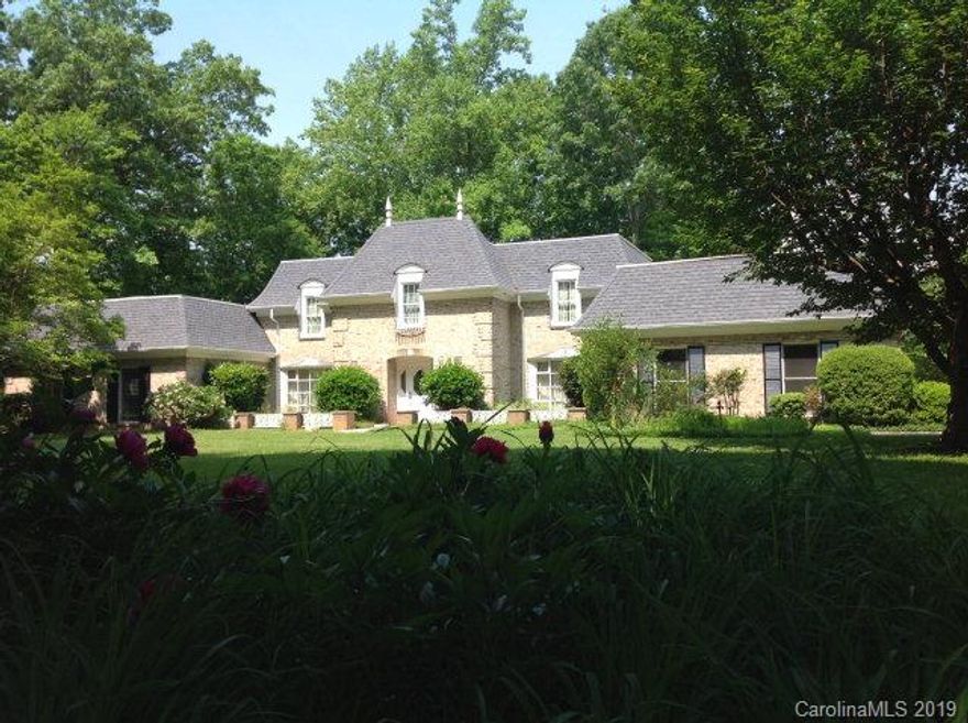 WORLD CLASS RESIDENCE - Once in a rare while will a truly magnificent home such as this be available. Built without compromise, the home reflects custom quality. It represents an elegant combination of sophistication and comfortable style, luxurious appointments, & detailed craftsmanship with +/-4000 heated square feet and 5 BRs, 3 Full BAs, & 2 Half BAs. The estate is set on an unusually large +/-5.5 acre sit overlooking Marion.  The main floor offers formals areas, a 2 story circular entry, and an indoor pool.  The upper floor gives 4 bedrooms including the master suite and 2 baths.  The basement level is finished with an additional bedroom, bath, den w/ fireplace, & bar room. The grounds include a full length patio and walkway to its own private tennis court. Priced at $375,000 for the new owner to add their own decorative touch.