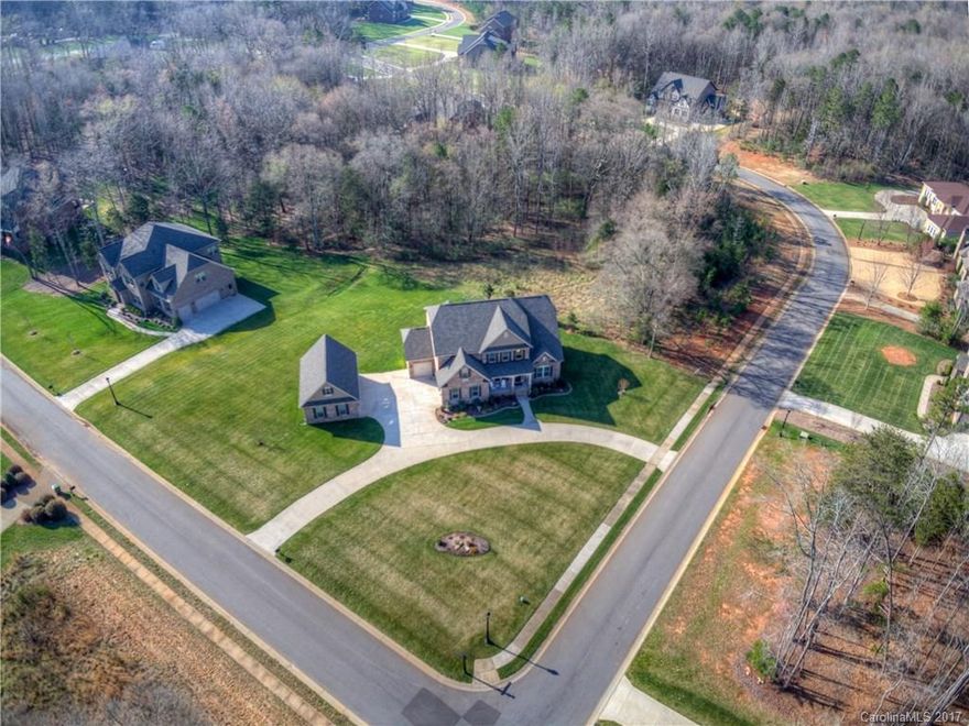 Executive home on estate lot in a gated neighborhood.  Circular drive, surround sound, custom master closet, private deck and details galore that are a must see!!  This is a car lover's dream! Attached garage w/ 3 spaces and detached garage w/ workshop and an addtl 3 spaces!  Just minutes from Ballantyne or Ft Mill.  Enjoy low SC taxes without giving up close proximity to Charlotte, entertainment and shopping.  Another 700 sqf above detached garage that can be finished! Best kept secret in SC!!