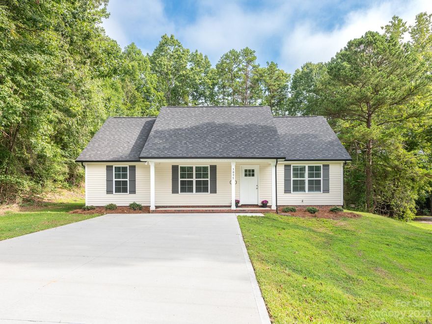Shows like new construction and NO HOA! This 3 bedroom, 2 bath ranch built in 2022 is nestled on a nice 1/2 acre lot on a quiet road with a rural feel. The covered rocking chair front porch is ready for a couple of rocking chairs and relaxation. Inside, you will find attractive luxury vinyl plank flooring throughout most of the home, with carpet in the bedrooms. The kitchen features gray shaker cabinets, a pantry, granite counters & stainless appliances - fridge included. The large primary suite has a true walk-in closet, granite counters and a great walk-in shower. And don't miss the separate laundry room off of the hallway with washer & dryer included. Oversized concrete driveway with room for 4 standard sized vehicles. Low Cabarrus County taxes (no city taxes) and great Cabarrus County Schools.  Located less than 2 miles from I-85 and approx. 5.5 miles from Downtown Kannapolis and all it has to offer.