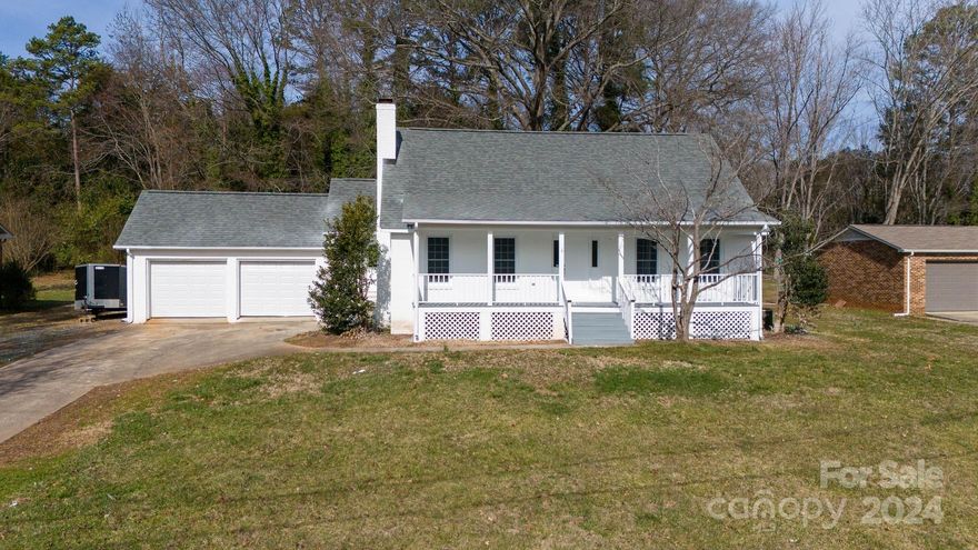 Welcome to your dream home! This beautifully updated 3-bedroom, 2.5-bathroom home offers the perfect blend of modern luxury and classic charm. Step into the fully renovated kitchen featuring a stunning hexagon-shaped tile backsplash, sleek quartz countertops, and brand-new stainless steel appliances. The primary suite on the main level is a true oasis, boasting a spacious walk-in closet, a luxurious free-standing tub, and a separate tiled shower. Enjoy year-round relaxation in the sunroom, or take in the serene views of the expansive 0.59-acre lot from the huge front porch. With an oversized 2-car garage with a workroom and a great location in the county, yet close to all modern conveniences, this home truly has it all. Come experience the epitome of comfort and style!