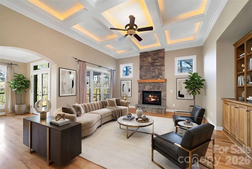 Rarely does a residence so flawlessly unite form and function, offering an atmosphere of refined luxury paired with exceptional comfort. From the moment you arrive, the striking custom metal front door and welcoming front porch hint at the elegance that awaits within. Step into the foyer and be greeted by a grand, light-filled living space wrapped in beautiful hickory floors. The open-concept kitchen—centered around a generous island—flows effortlessly between two distinguished living areas, each enhanced by its own stone fireplace. Expansive windows frame serene views of the level backyard, where direct access to Lake Atagahi allows you to kayak or fish from the privacy of your own property. The main-level primary suite provides a luxurious retreat with a spacious bath and walk-in closet. This level also features a formal dining room, a guest suite, a walk-in pantry, and a well-appointed laundry room—perfectly designed for everyday ease. Upstairs, two ensuite bedrooms offer comfort and privacy, complemented by a media room and a flexible bonus space ideal for an art studio, sewing room, or home office. The 2,419-sq-ft lower level is fully framed, heated, and primed for transformation—ready to become additional living quarters, a workshop, or an exceptional recreational haven. First time home buyers pay $14000 amenity fee at closing or $16000 at the end of the year