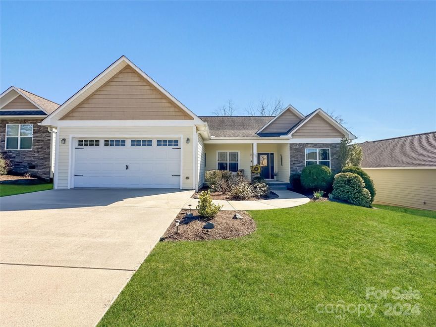 Welcome to the epitome of ease and comfort in a charming community setting. Perfect for first-time homebuyers or those looking to downsize, this delightful 3-bedroom, 2-bathroom house offers the simplicity of one-level living combined with modern amenities. The open floor plan seamlessly connects living spaces, ideal for entertaining or a cozy night in. Enjoy the luxury of an upgraded kitchen featuring granite countertops, stainless steel appliances, and beautiful cabinetry. Hardwood floors gleam throughout the main area, while ceramic tile accents the bathrooms, blending durability with style. Your new home is part of Weaver Village Walk—a quaint neighborhood of just 19 homes, where your lawn care is managed, giving you more time to explore and enjoy the nearby attractions of downtown Weaverville. Park with ease in your own 2-car garage and take pride in the home's durable fiber cement siding and elegant stone exterior finishes. Embrace the beauty of small-town living.