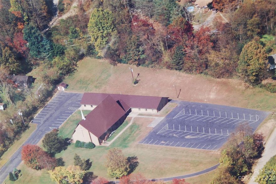 Formerly a Church with multiple rooms and meeting spaces, two kitchens, 6 bathrooms ( no showers), 80+ paved parking spaces, US 70 frontage with 2 access points currently, Zoned R-3. Outside Asheville City limits, County taxes only. Security System. Listed near tax value.