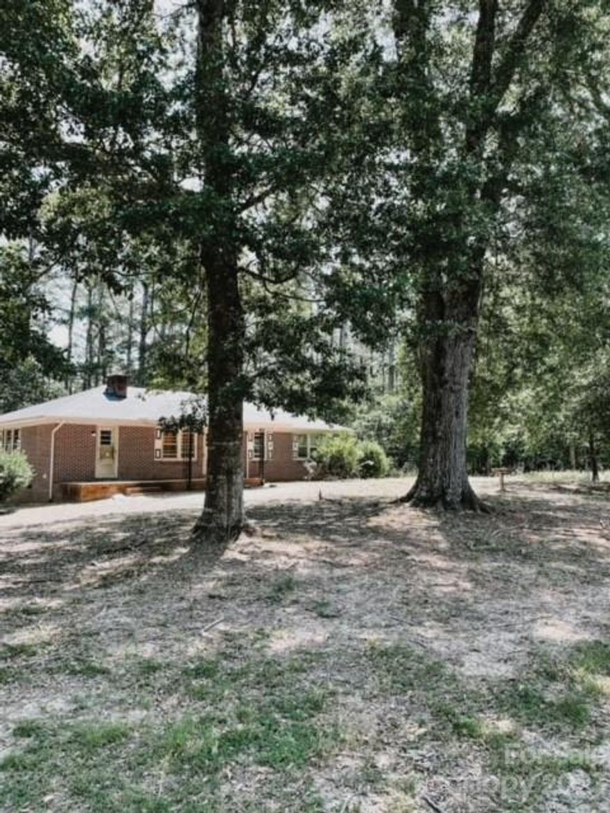 SHORT SALE!! Call for details, necessary addendum is attached. Please use original Attorney to close loan and will be way smoother.  Nestled amidst 12 sprawling acres of natural beauty this charming brick home offers the perfect blend of tranquility and potential. Rustic charm meets modern possibilities. Woodlands combined with pastures. Barn with stalls. Metal chicken boxes. Well house shed. Step inside to embrace the warmth of original wood floors and the ambiance of a cozy brick fireplace. A treasure trove of trees perfect for nature and hiking enthusiasts. Organic gardens are just a slice of what awaits you in this forever homestead. 25 minutes to Rock Hill and 40 minutes to Charlotte.