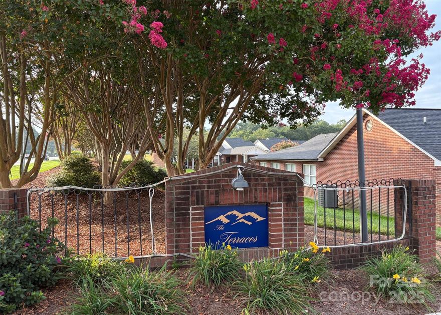 The Terraces are a highly desirable 55+ community in Denver, NC with a community Club House and close proximity to restaurants/shopping.  You will adore this all one level, move-in ready END UNIT. This home features 2 good size bedrooms, 2 full baths, and a Vaulted ceiling in the Living Room.  The Kitchen is spacious with lots of cabinetry, a pantry, and views from the kitchen into the vaulted Living Room with lots of natural light. The Primary Suite features an ensuite bath with a large walk in closet.  The carpet is just over a year old and a newly installed microwave and attic fan have been added as well. You will enjoy the outdoors on your patio that backs up to a landscaped berm for privacy rather than another home.  There's even an additional storage area off the backyard patio and a carport with additional parking on your own driveway.