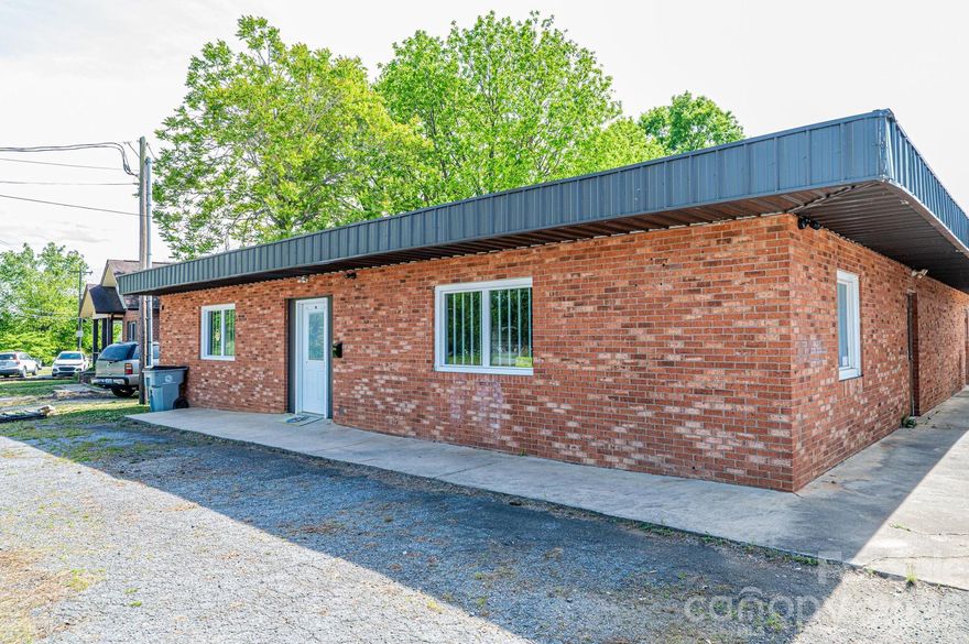 ATTENTION INVESTORS! Rare opportunity to own a versatile commercial property just minutes from Downtown Lenoir with easy access to Hwy 18/Morganton Blvd. This well-maintained brick building sits (3 seperate parcels) on a level corner lot and is configured for up to four separate units—two currently leased, offering immediate income potential. Features include a loading dock and rear garage door, mini-split system in the front unit, one heating/cooling unit in the 3rd unit, a 220-volt electrical service in the rear workshop, which also includes an enclosed office. City water and sewer are in place, with additional water access available in the second unit. Roof has been recently tarred with no known leaks per owner. Natural gas is hooked up but not turned on 4 bathrooms; 2 in the front section, 1 in the 3rd section and one in the back warehouse section.  Excellent investment opportunity with flexible use options!