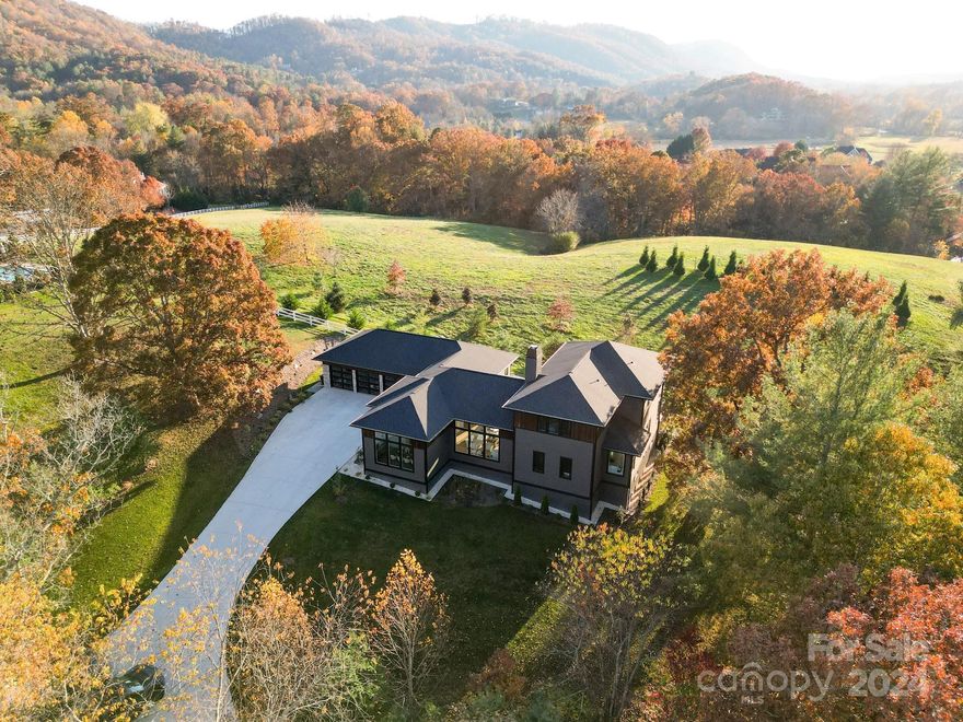 Experience the epitome of luxury living in this stunning Modern Prairie home. Wake up to breathtaking sunrises streaming through the dining and kitchen windows, setting the perfect ambiance for your morning coffee and gourmet breakfast in the chef's kitchen. Wind down against the backdrop of spectacular sunsets over the mountains from the 6ft deep pool, seamlessly transitioning from the kitchen/living room area to the back porches. With 13-foot ceilings and expansive windows in every room, this home boasts an airy, open-flow concept flooded with natural light, all while ensuring utmost privacy. Crafted with passion and remarkable craftsmanship, every detail exudes quality and sophistication, making this residence a true dream home. Nestled in a highly desirable gated community, this home offers both elegance and convenience. Available fully furnished upon request. 5th Full bathroom in sauna.  252 sq ft sauna is heated square footage and is accessible from the pool deck.